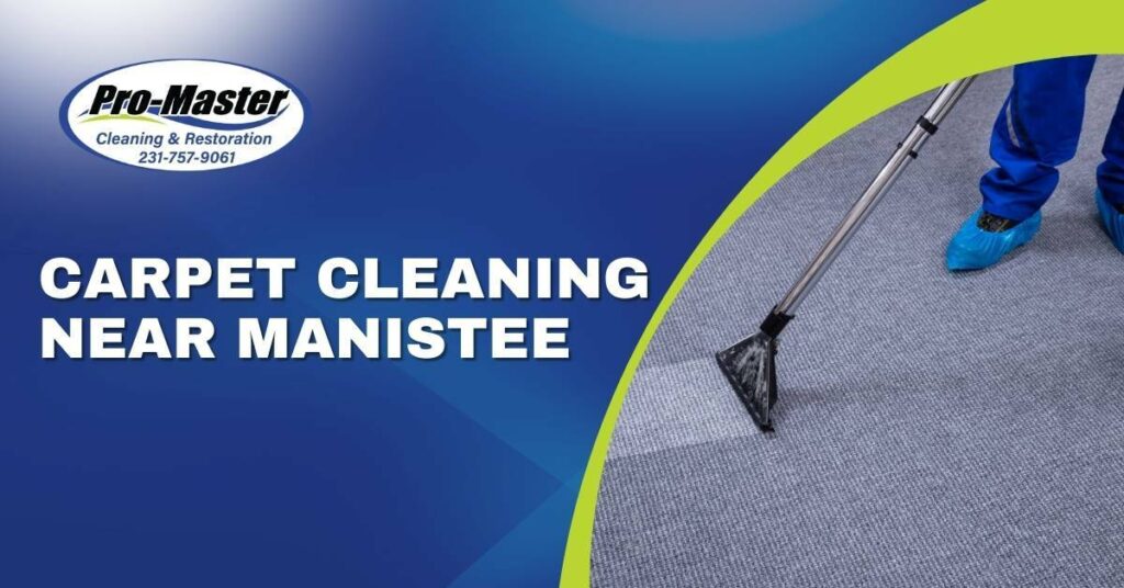 A Professional Carpet Cleaner With Blue Pants and Shoe Covers Vacuuming Carpet | Carpet Cleaning Near Manistee, MI | Pro-Master Cleaning & Restoration